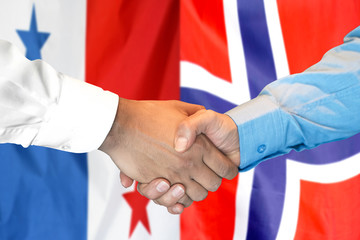 Handshake on Panama and Norway flag background.