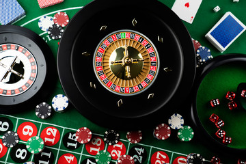Roulette table in casino. Casino felt green table with red and black numbers. Stack of poker chips.