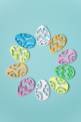 Easter background. Paper easter eggs. Greeting card for the holiday. Multicolored details, bright pastel frame background. A lot of elements.