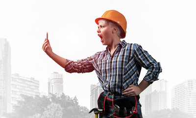 Expressive blonde woman in workwear and hardhat