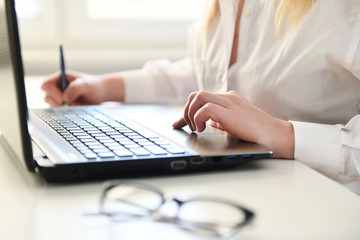 Fototapeta premium Woman working on modern computer. Laptop keyboard detail with beautiful nails hand.Quarantine, isolation and work from home during pandemic epidemic coronavirus. 
