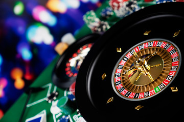 Roulette table in casino. Casino felt green table with red and black numbers. Stack of poker chips.