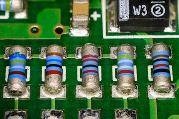 Roller resistors on a printed circuit board in macro detail.