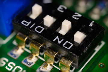 Microswitches on a printed circuit board in macro detail.