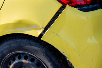 scratched car with damaged paint in crash accident or parking lot