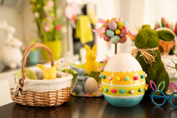 Easter theme. Easter decorations. Easter eggs in basket and easter bunny. Bouquet of spring flowers.