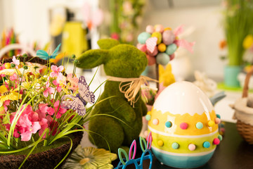 Fototapeta premium Easter theme. Easter decorations. Easter eggs in basket and easter bunny. Bouquet of spring flowers.