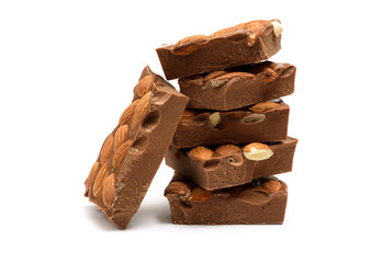 Stack of milk chocolate chunks with almonds isolated on white background