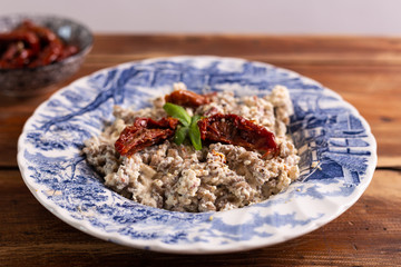 Fusilli pasta with tofu cream, dried cherry tomatoes and basil. Ideas for vegan recipe. Helathy food, fast lunch, vegan protein.