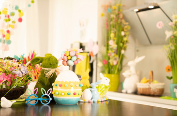 Easter theme. Easter decorations. Easter eggs in basket and easter bunny. Bouquet of spring flowers.