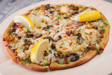 Pizza with cheese and lemon