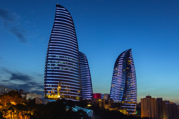 Baku panorama. Night city. Beautiful evening view of skyscrapers. Flame Towers in the evening. Modern architecture. Azerbaijan capital. Night view of Baku.