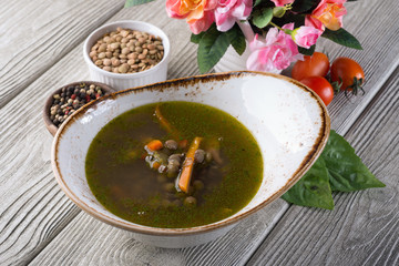 Pea soup in a restaurant on a white wooden table