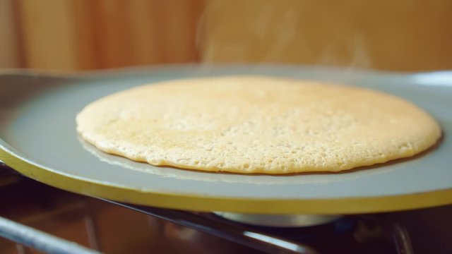 Flapjack, tortilla, pizza, bake fry pancake in pan. Steam is coming. Close up.