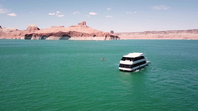 Drone Shot Orbiting Around A House Boat On Lake Powell