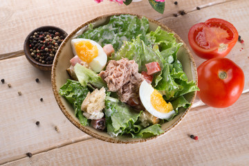 Salad with greens, meat, eggs and tomatoes