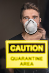 Coronavirus, quarantine and pandemic concept. Sad and sick man of corona virus looking through the...