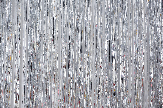 Christmas and New Year background, tinsel or shiny ribbons