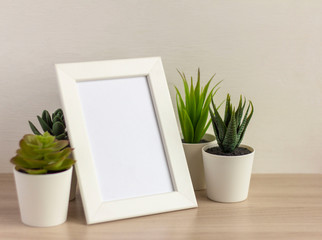An empty photo frame on a table or shelf with a copy of the space