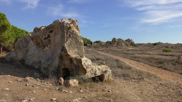 Remains of the walls of the ancient necropolis. Filmed on the territory of the park Royal Tombs, near Paphos, Cyprus.