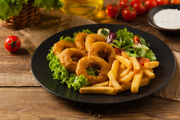 Roasted squid rings with fries.