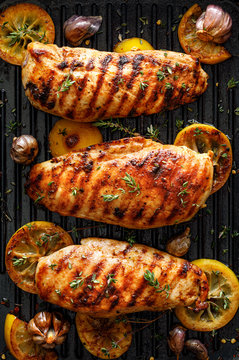 Grilled Chicken Breasts With Thyme, Garlic And Lemon Slices On A Grill Pan, Top View