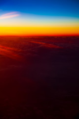 Sunrise above clouds from airplane window with space for your text