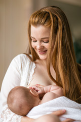 Cute three-month-old girl in her mother’s arms