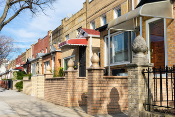 A Row of Old Brick Homes along the Sidewalk in Astoria Queens of New York City