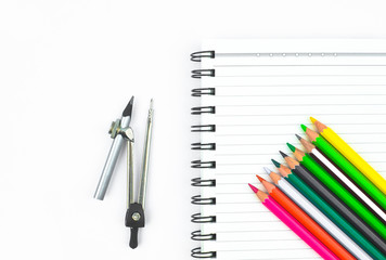Study materials containing a row of different color pencil,a pencil compass and a diary