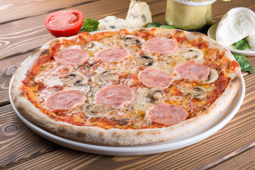 Delicious pizza with cheese, tomatoes, olives and greens