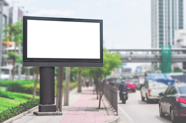 Obraz premium led blank billboard white screen side road in city. ad mockup copy space for advertising banner near bus stop in metropolis.