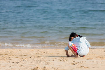 海水浴場で砂遊びをしている可愛い子供