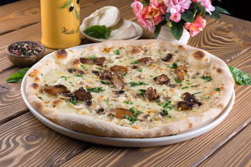 Delicious pizza with cheese, tomatoes, olives and greens