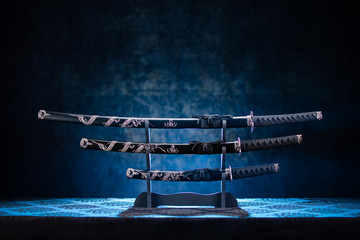 Three swords on stand, with dramatic blue light