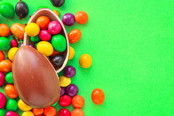 Fototapeta na wymiar chocolate egg and candy easter decor, menu concept background. top view. copy space for text