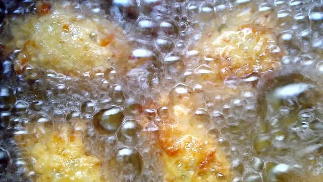 Frying traditional Brazilian rice balls