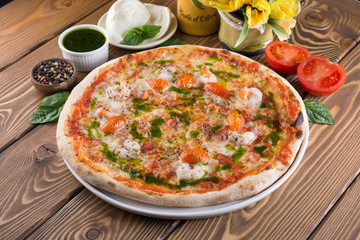 Delicious pizza with cheese, tomatoes, olives and greens