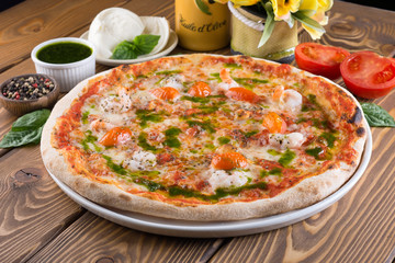 Delicious pizza with cheese, tomatoes, olives and greens
