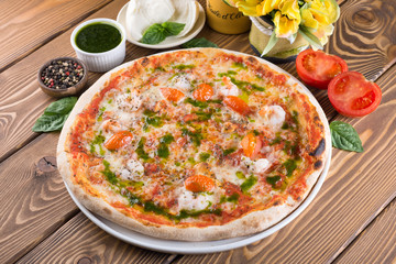 Delicious pizza with cheese, tomatoes, olives and greens