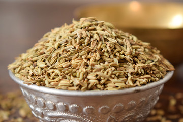 Dried Fennel Seeds in a Silver bowl on wooden old Table. Rustic Style