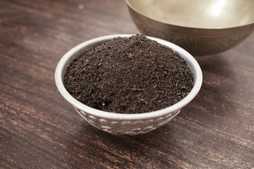 Dry Tea in a Silver bowl on wooden old Table. Rustic Style