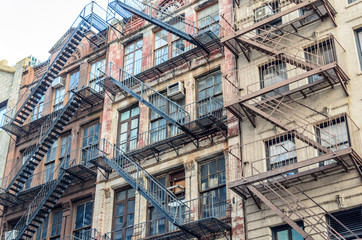 Fototapeta na wymiar Traditional Apartments with Fire Escape Ladders in New York, USA