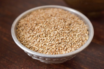 Dried Sesame Seeds in a Silver bowl on wooden old Table. Rustic Style 