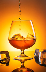 Glass with whiskey with spray