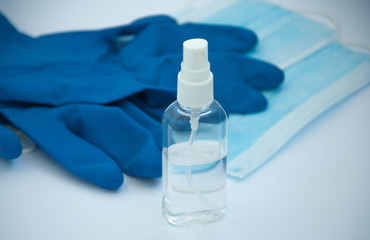 Set of antiseptic items. Medical mask, medical gloves, bottle of antiseptic hand spray on white background