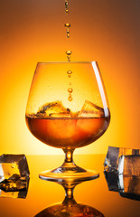 Glass with whiskey with spray