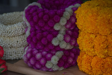 Mixed flower garland on shelf in a market