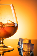 Glass with whiskey with spray