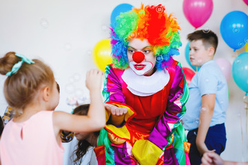 Children play with a clown